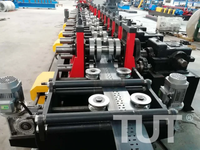 Cable tray roll forming line with the punched tray profile leaving the forming stations