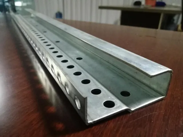 Formed steel profile with punched holes produced on a custom roll forming line
